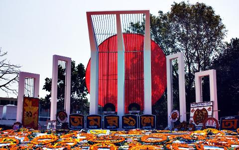 5-Day Dhaka Cultural Heritage Tour: Floating Markets & River Life Experience The Shaheed Minar memorial in Dhaka, Bangladesh, is adorned with floral tributes and illuminated by the sun.