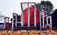 5-Day Dhaka Cultural Heritage Tour: Floating Markets & River Life Experience The Shaheed Minar memorial in Dhaka, Bangladesh, is adorned with floral tributes and illuminated by the sun.