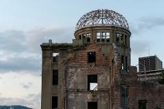 The skeletal remains of the Hiroshima Peace Memorial (Genbaku Dome) stand against a cloudy sky.