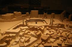 This is a miniature architectural model of the Masjid al-Haram mosque in Mecca, including the Kaaba, courtyards, minarets, and surrounding buildings.