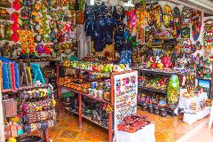 A vibrant souvenir shop displays a colorful array of handicrafts, clothing, and decorative items.