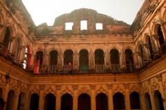3-Day Dhaka Heritage & Culture Tour — Old Palaces, Lost Cities & Zamindari Mansions An ancient, ruined courtyard building with ornate arches, columns, and decorative carvings stands under a bright sky, hinting at a rich past.