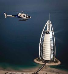 A helicopter flies near the Burj Al Arab hotel in Dubai.
