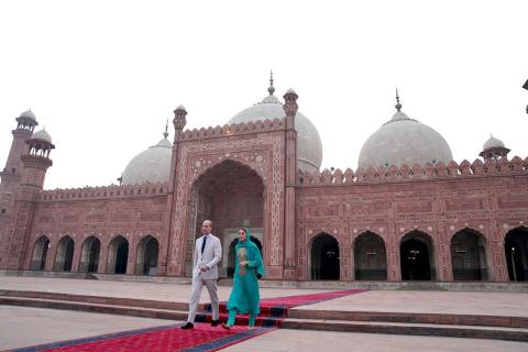 Prince William and Kate Middleton walk on a red carpet in front of the Badshahi Mosque in Lahore, Pakistan.