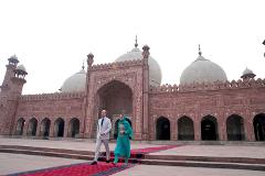 Prince William and Kate Middleton walk on a red carpet in front of the Badshahi Mosque in Lahore, Pakistan.