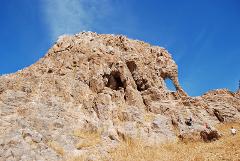 A striking rock formation resembling an elephant with a clear blue sky in the background.