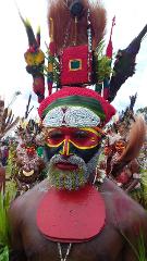 A man in elaborate face paint and tribal attire poses at the Mount Hagen Festival & Paiya Show.