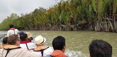 Bangladesh in 7 Days: Dhaka, Sreemongol & the Sundarbans People in a boat are cruising through a mangrove forest on a cloudy day in Bangladesh.