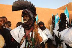 This captivating image showcases a group of Wodaabe men adorned in elaborate headdresses and traditional attire during the Gerewol Festival in Niger.