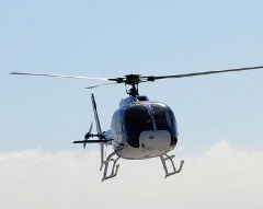 A helicopter is flying in the sky.