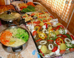 A table laden with a variety of Somali dishes, including rice, vegetables, and meat, suggesting a festive occasion or cultural celebration.