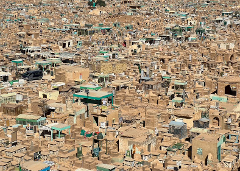 This is a vast, densely-packed cemetery with many tomb structures in varying sizes and states of repair, creating a chaotic yet strangely organized landscape.