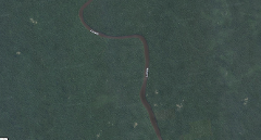 An aerial view shows a winding river through dense, dark green jungle.