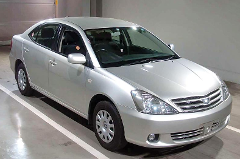 A silver Toyota Allion sedan parked in an indoor parking space, captured from a low angle showing the front and side profile.