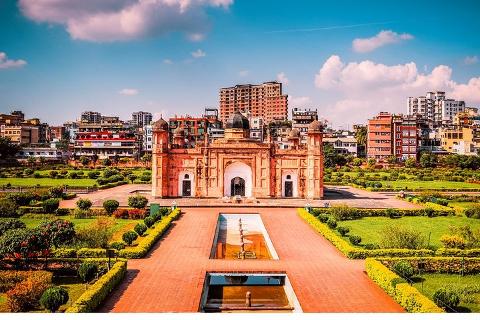 Lalbagh Fort in Dhaka, Bangladesh, with its iconic Mughal architecture and well-manicured gardens, stands as a testament to the region's rich history and cultural heritage, under a bright sky.