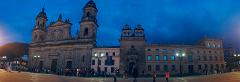 Gran Tour incluyendo Bogotá, Medellín, Nuquí y Valle del Cocora - 11 Días A wide-angle shot showcases the Primatial Cathedral of Bogotá and the Palace of Justice against a twilight sky, with people strolling in the plaza.