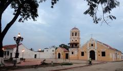 Mompox & Aracataca Cultural Journey (3 Days / 2 Nights) A colonial church and bell tower stand in Mompox, Colombia, bathed in the soft light of dusk.