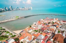 Darien Gap, Rainforest, and Culture from Panama Here's a description of the image:An aerial view captures Panama City's blend of historic architecture with modern skyscrapers along the coast, showcasing a vibrant urban landscape.