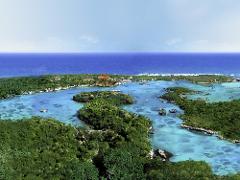 Riviera Maya Airplane Tours A vibrant, high-angle view showcases the Riviera Maya with lush green islands, turquoise water, and the distant ocean under a clear blue sky.