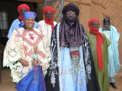 A group of six people, some wearing traditional turbans and clothing, pose for a photo.