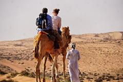 Camel safari trekking tour in the desert Wahiba Sands