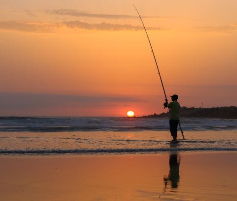 Man_fishing_at_sunset_in_Mehdia_beach