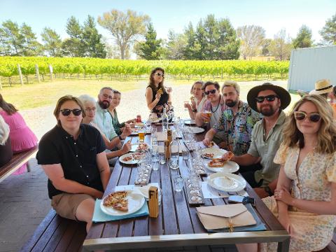 Murrumbateman guests sitting and dining together outdoors.