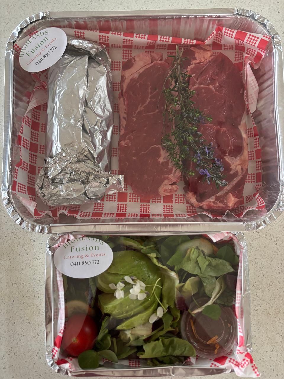 Local lamb cutlets or beef steak with salad & garlic bread for two