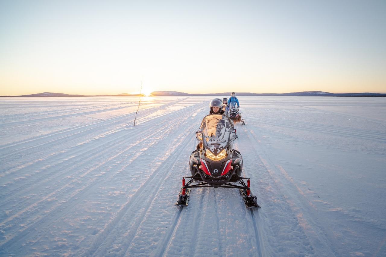 Snowmobile Daytime - 2 people driving one machine