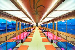 The interior of a traditional Japanese-style boat, with long tables and cushions arranged down the center, featuring decorative panels and artwork on the ceiling and windows.