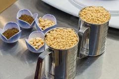 In a cooking class in Asakusa, measuring cups and small bowls hold ingredients for Japanese snacks like pine nuts and ground ingredients.