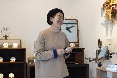 Fukushima Aizu Hongo Pottery Tour – 4.5-Hour Kiln Visit & Guided Walk, Interact with Master Artisans A collection of ceramic cups and saucers in various earthy tones and styles are displayed on shelves in a glass cabinet.
