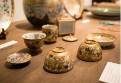 Nationally Treasured Technique - Kinsai Pottery Studio Tour The image shows an assortment of exquisite, gold-decorated pottery, likely displayed in a studio setting, hinting at the craftsmanship detailed on the "Kinsai Pottery Studio Tour" page.