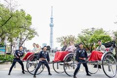 Asakusa Kimono Rental Plan - Choose From a Variety of Beautiful Kimonos A group of people pose with kimonos and rickshaws in front of the Tokyo Skytree.