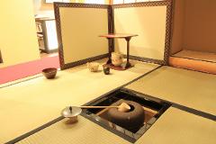 Geisha and Tea Ceremony! Experience traditional Japanese culture in Asakusa.(English Support Available) A traditional Japanese tea ceremony setting features tatami mats, a low table, tea bowls, and a kama for boiling water.