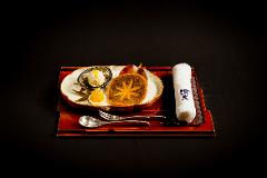 Learn Nagoya Yuzen Dyeing and Have a Kimono Dressing Experience in a Luxurious Traditional Japanese Restaurant A beautifully presented dessert of persimmon, ice cream, and what appears to be a small dumpling sits on a decorative tray with a rolled towel.