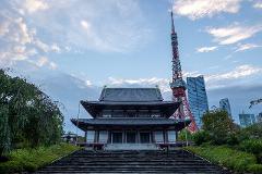 Meisatsu Zojoji Temple - A Journey to Tokyo’s Cultural Origins A majestic temple stands tall with a historic architectural style, set against a backdrop of modern skyscrapers and the iconic Tokyo Tower.