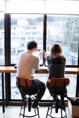 A couple sits by a window, enjoying tote-yaki crepes.