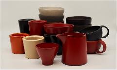 Experience 200 Years of Craftsmanship: Wajima Lacquerware Studio Tour (Visit a craftsman's home) A collection of Japanese Wajima lacquerware, including bowls, cups, and a pitcher in various colors and sizes, is artfully arranged against a plain white background.
