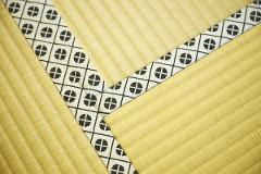 A close-up of tatami mats with a decorative black and white border.